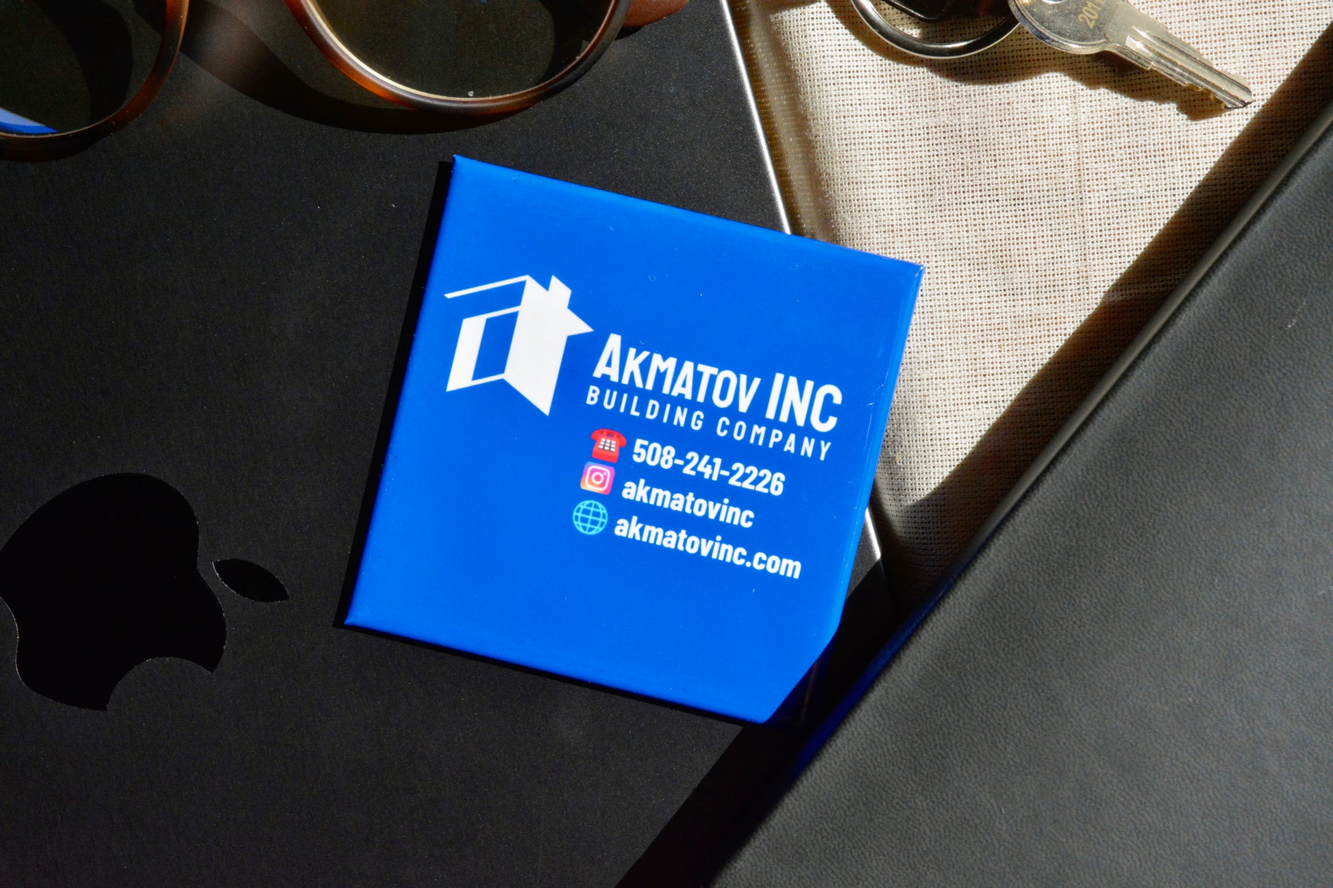 Custom blue logo magnet displayed on a laptop