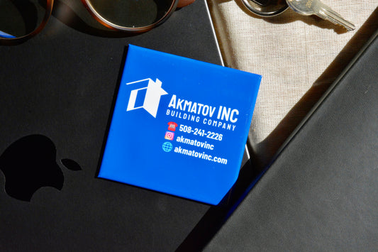 Custom blue logo magnet displayed on a laptop