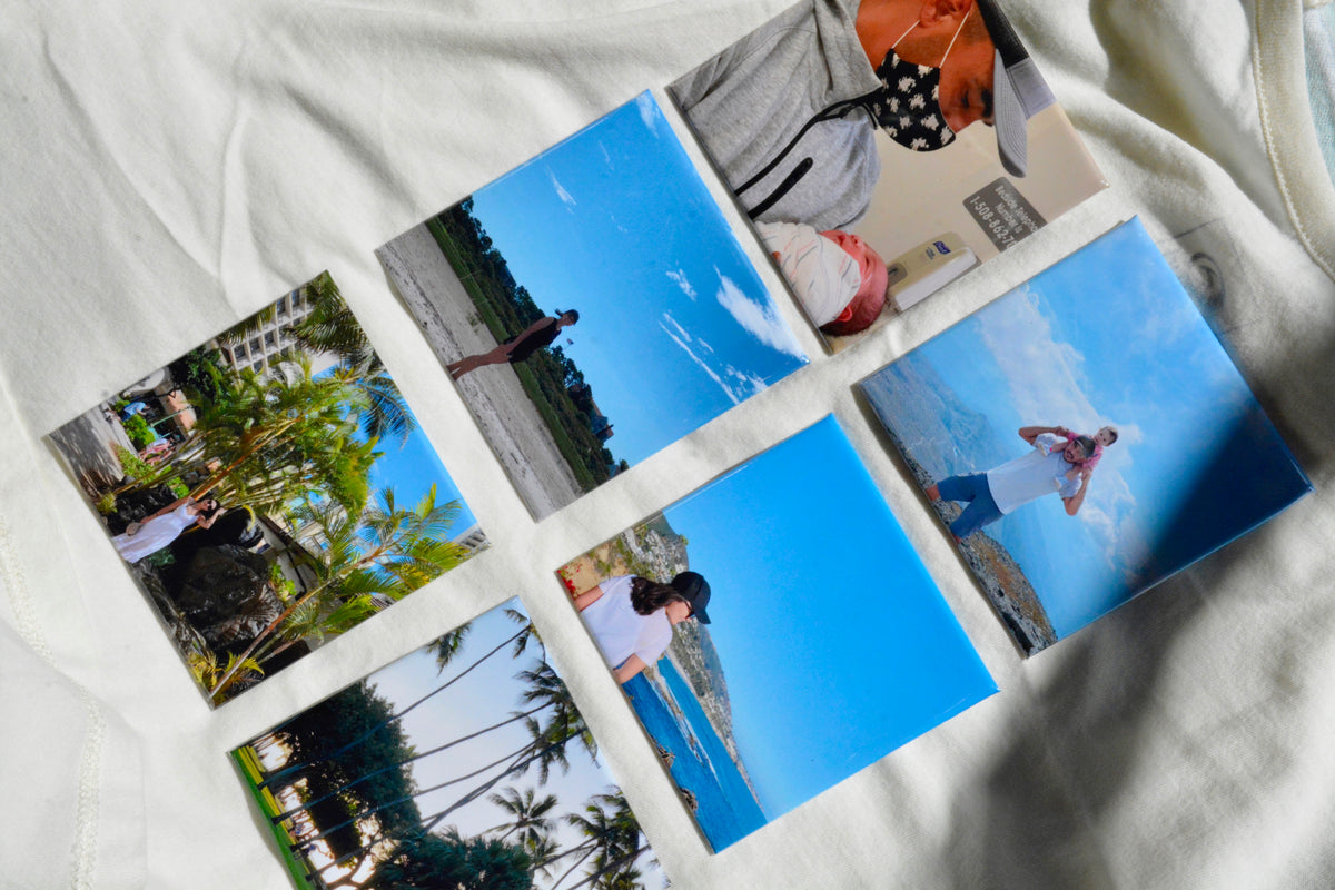 Colorful custom 3x3 photo magnets displayed on white fabric background