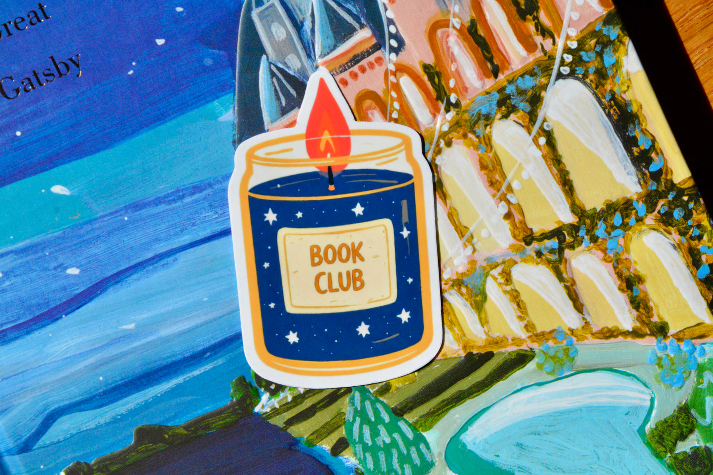 Blue-orange candle sticker on great gatsby book cover