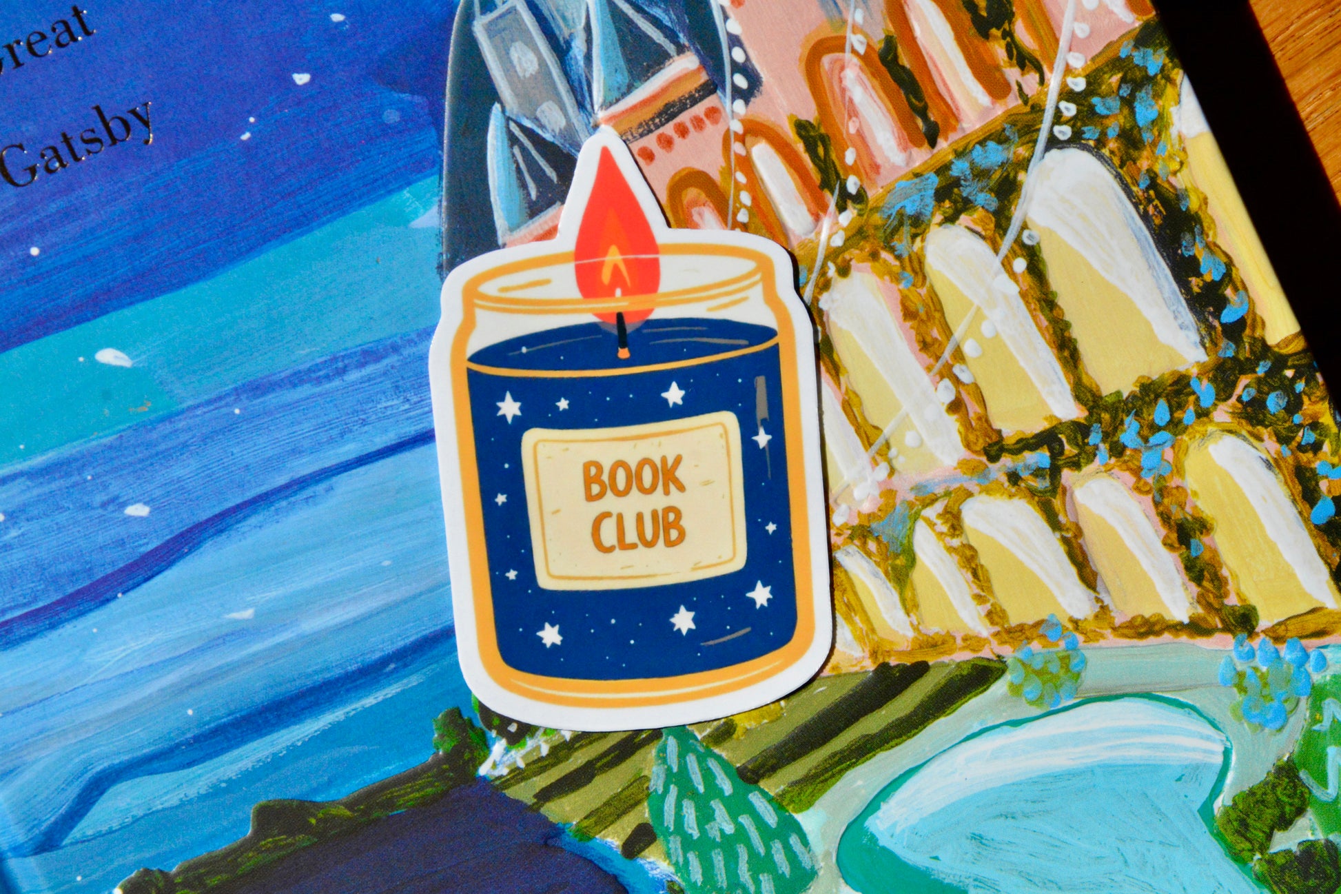 Blue-orange candle sticker on great gatsby book cover