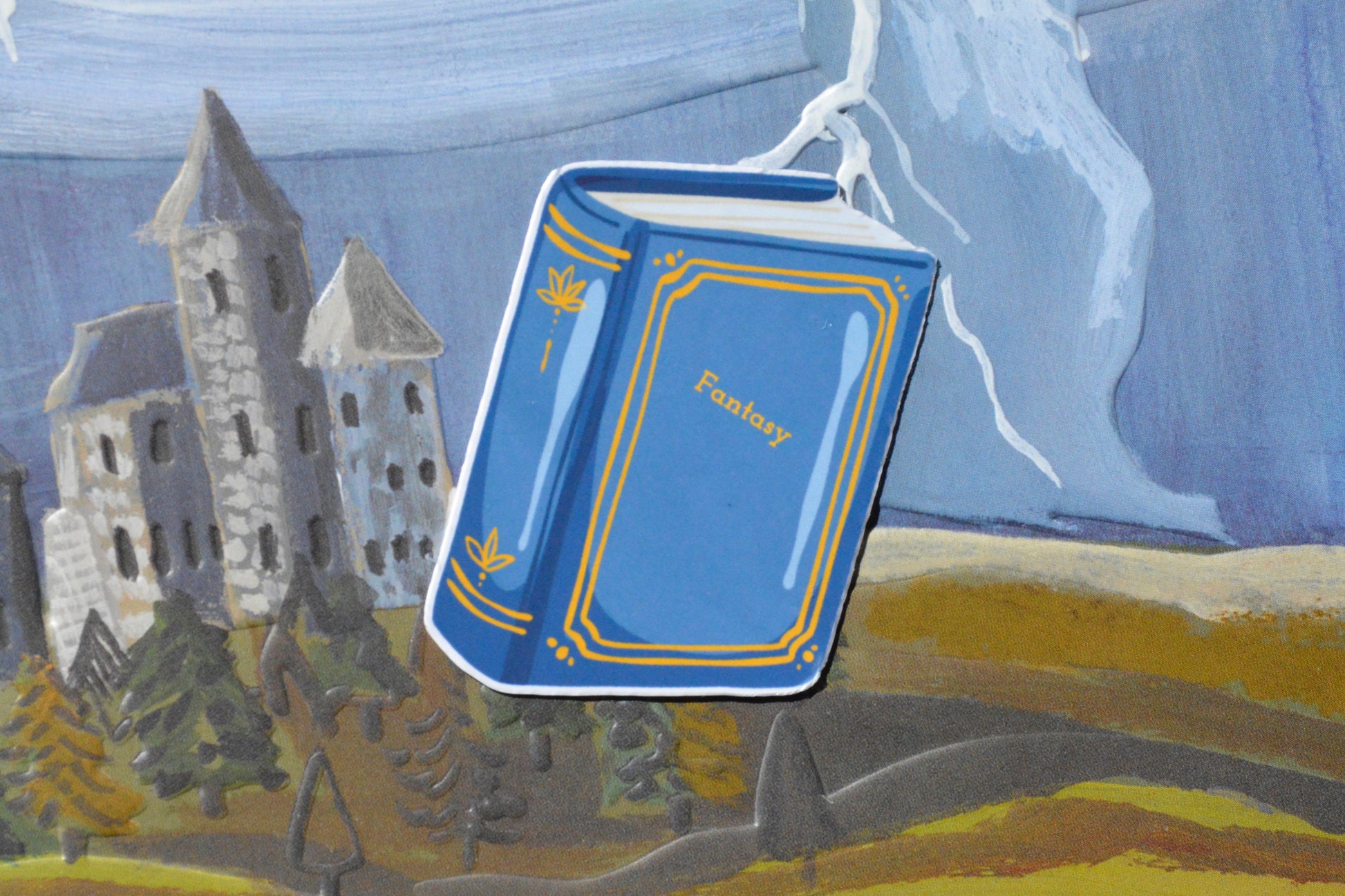 blue sticker book named fantasy on a colorful background