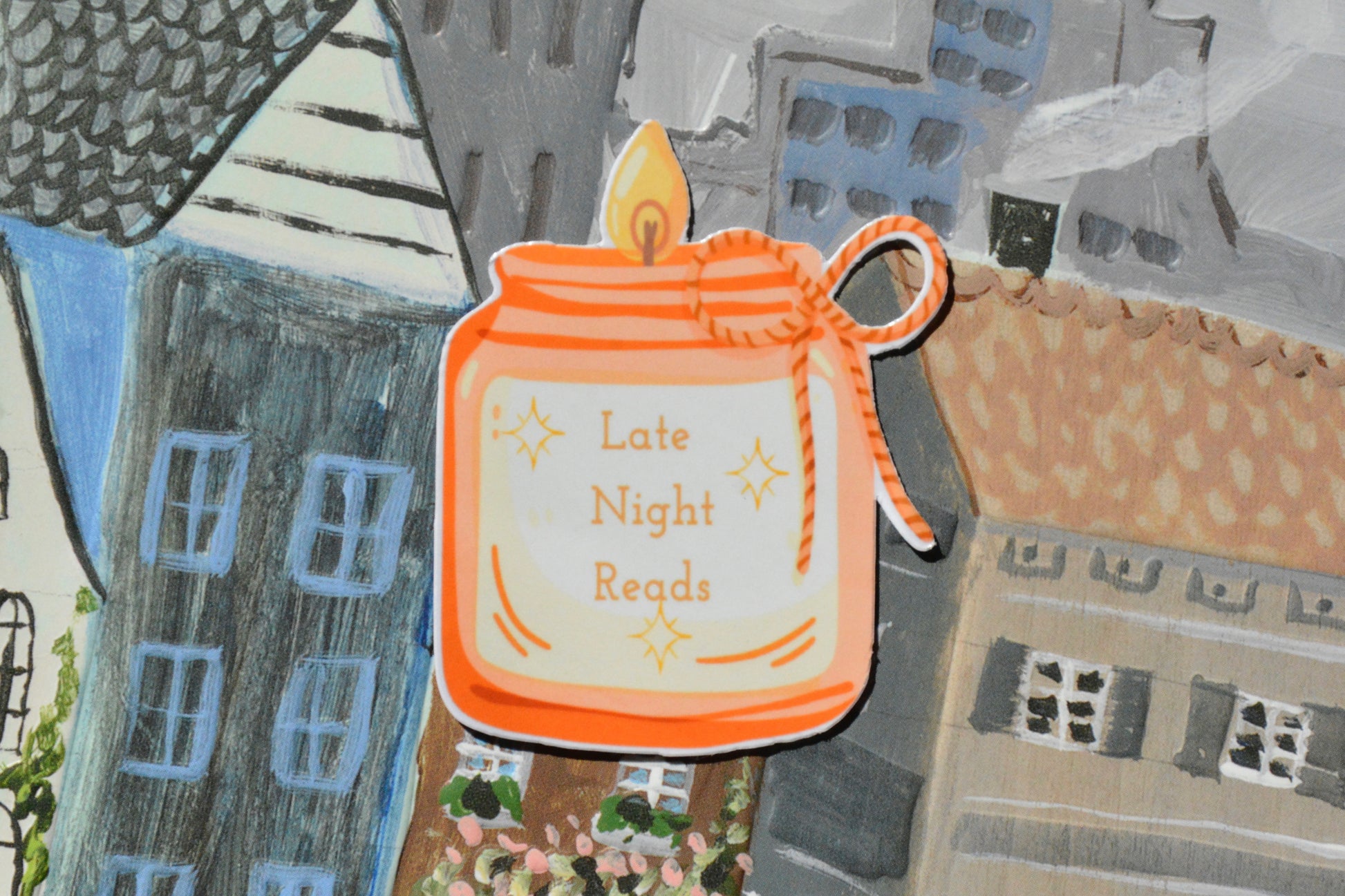 candle sticker with the text late night reads on a city background