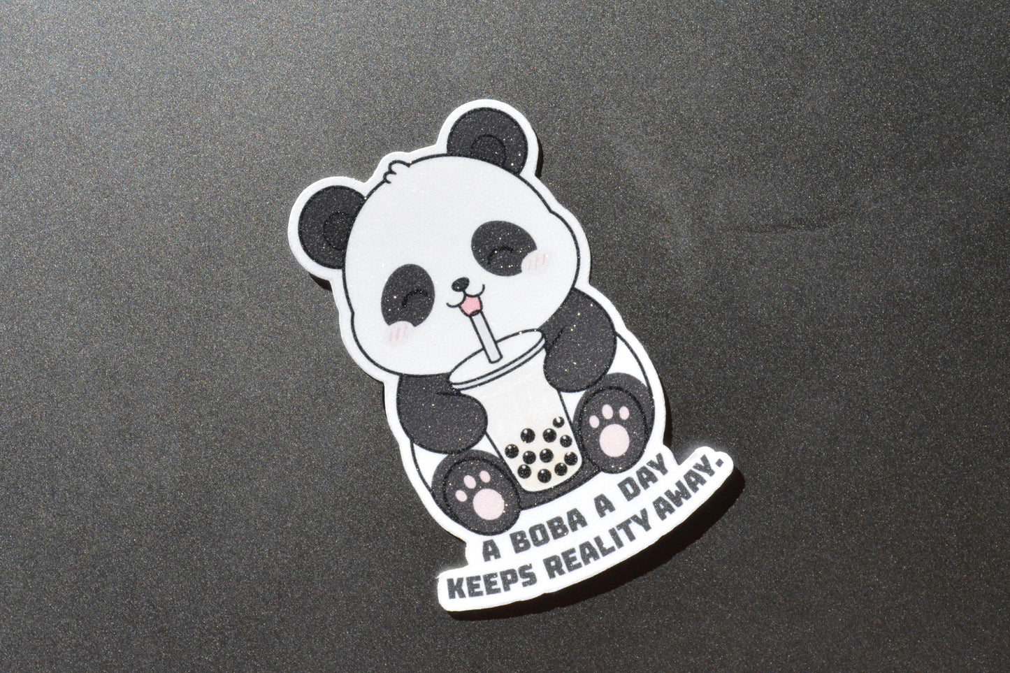 Happy panda on a sticker that says a boba a day keeps reality away