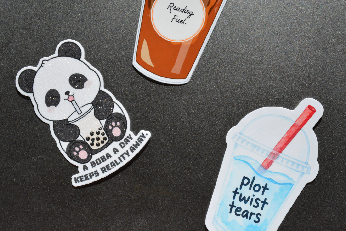Plot Twist Sticker alongside with a boba a day keeps reality away and reading fuel coffee sticker