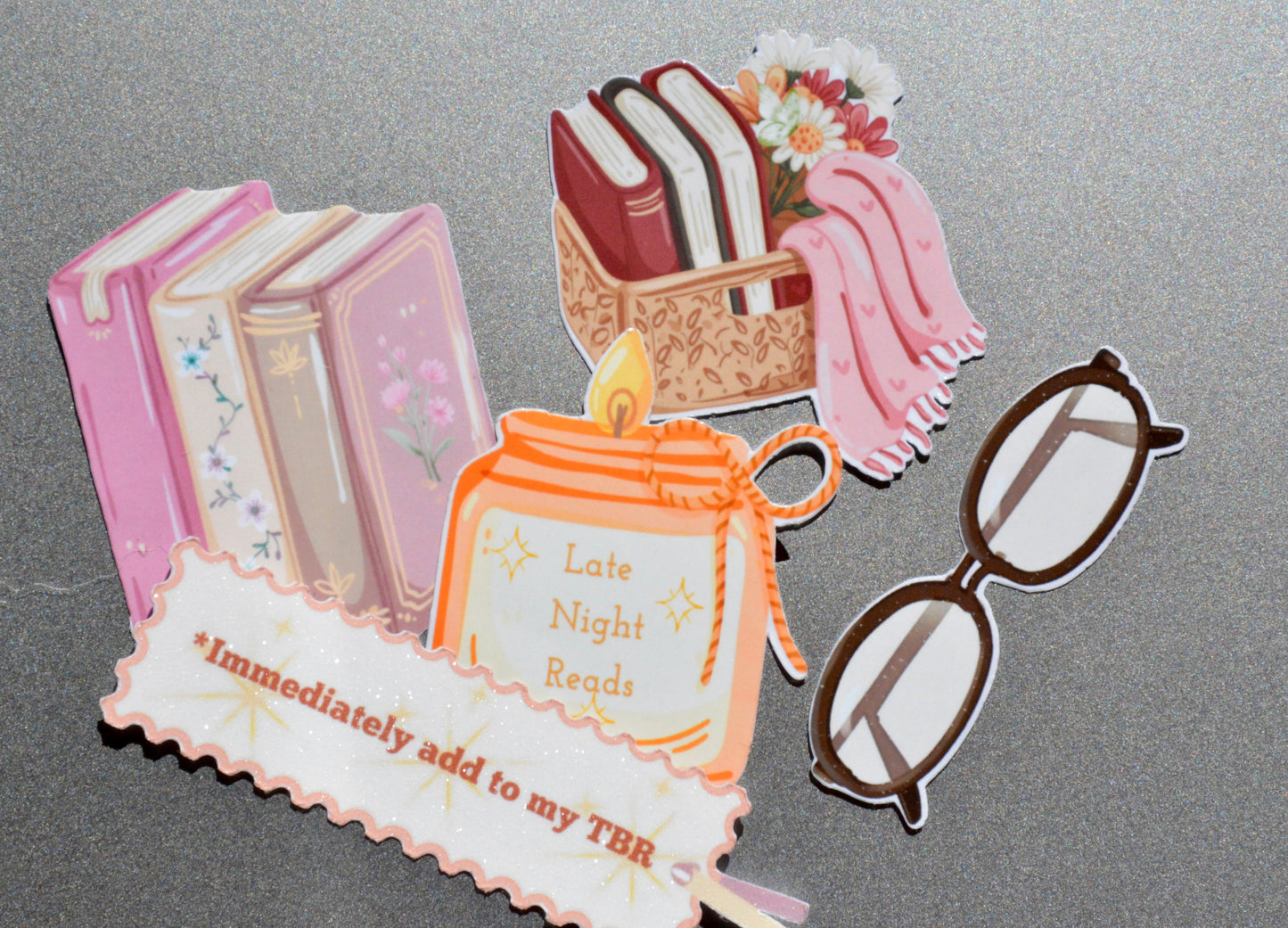 collection of book basket, reading glasses, candle, book stack and immediately add to my tbr stickers