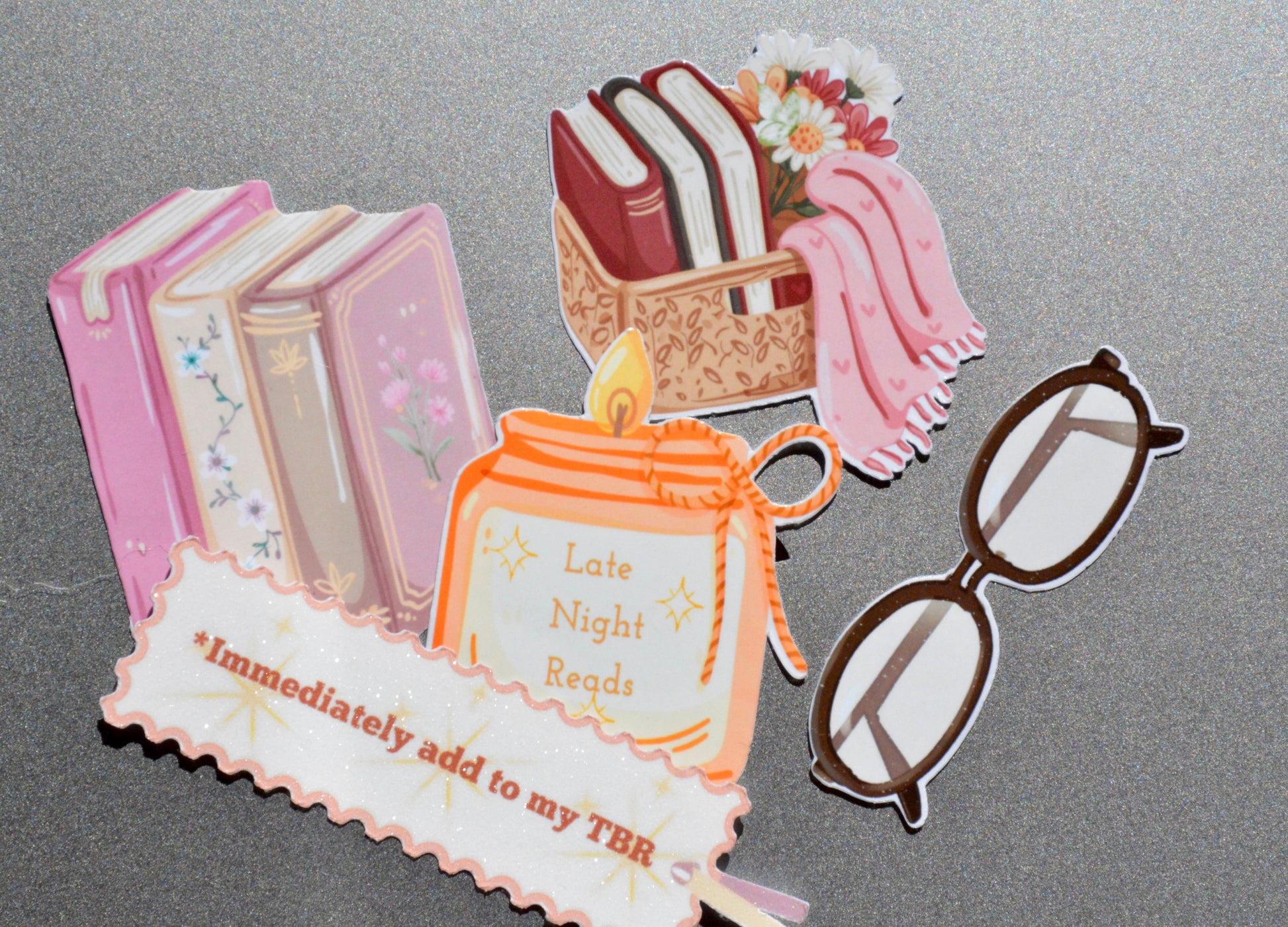 collection of book basket, reading glasses, candle, book stack and immediately add to my tbr stickers