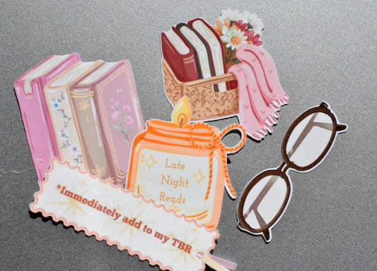 collection of book basket, reading glasses, candle, book stack and immediately add to my tbr stickers