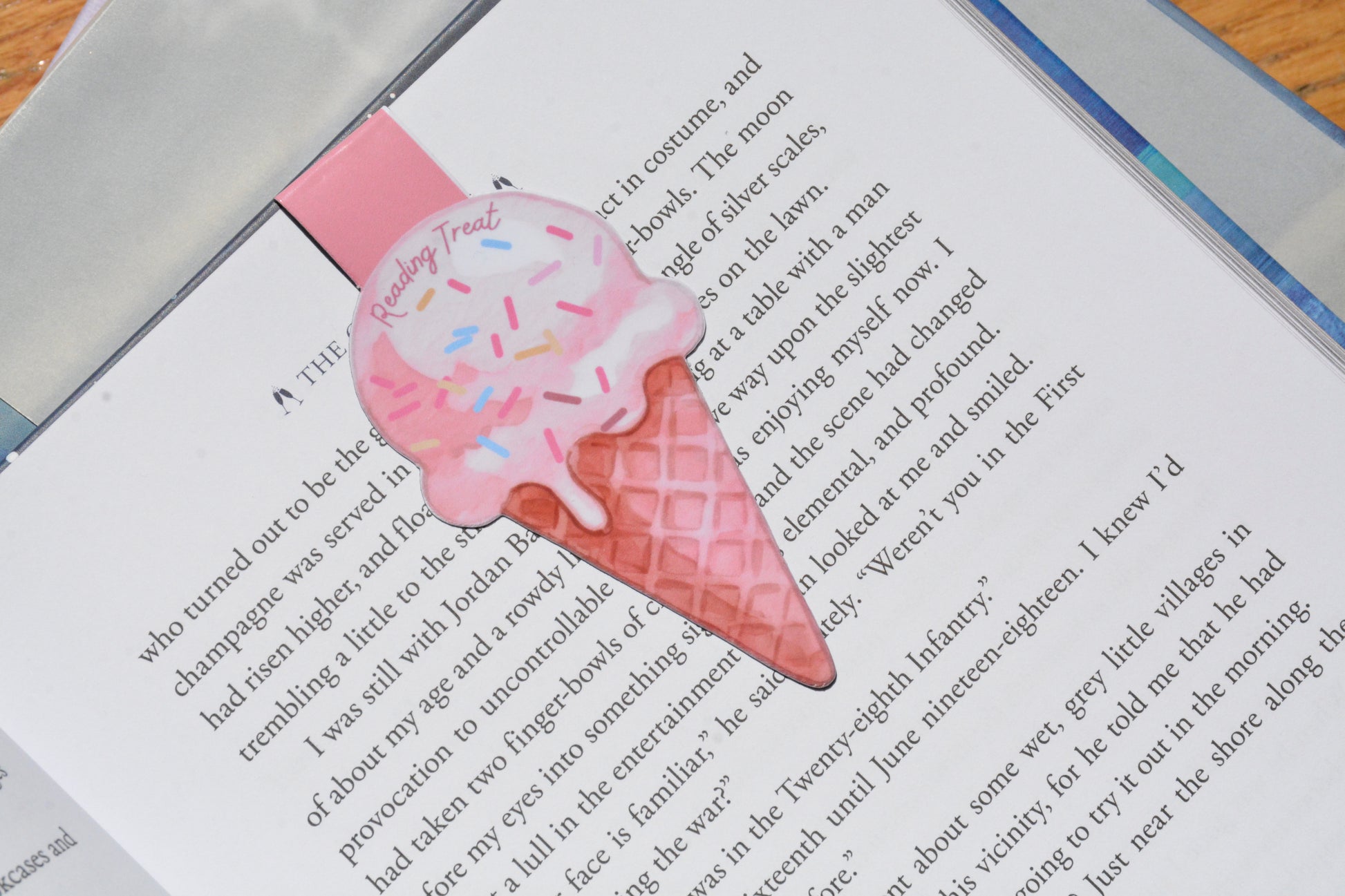 Cute ice cream magnetic bookmark clipped inside an open book, featuring a watercolor "Reading Treat" design for book lovers.