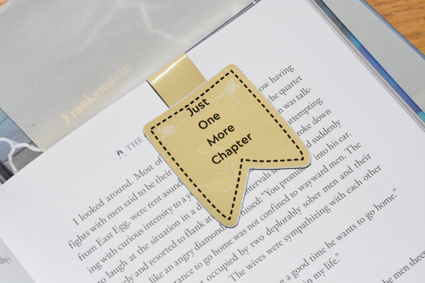 Yellow "Just One More Chapter" magnetic bookmark clipped inside an open book, handmade for book lovers.