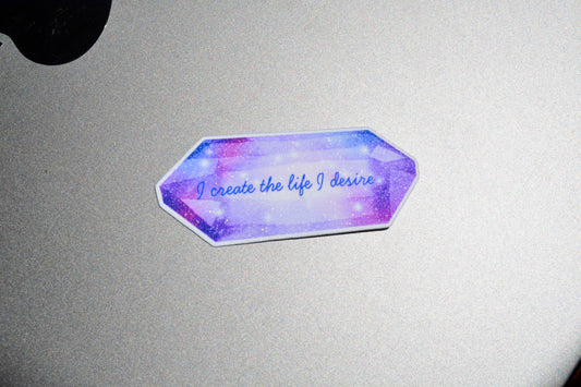 I create the life I desire sticker is on top of the grey surface