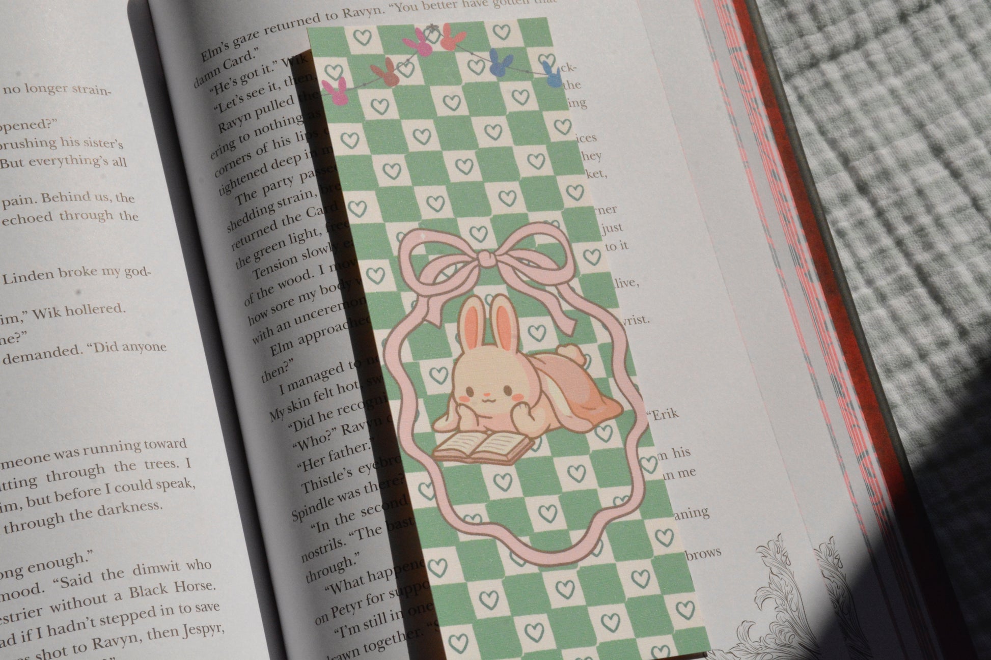 Oversized handcrafted bunny bookmark with a pink bow frame and soft pastel green checkerboard design.
