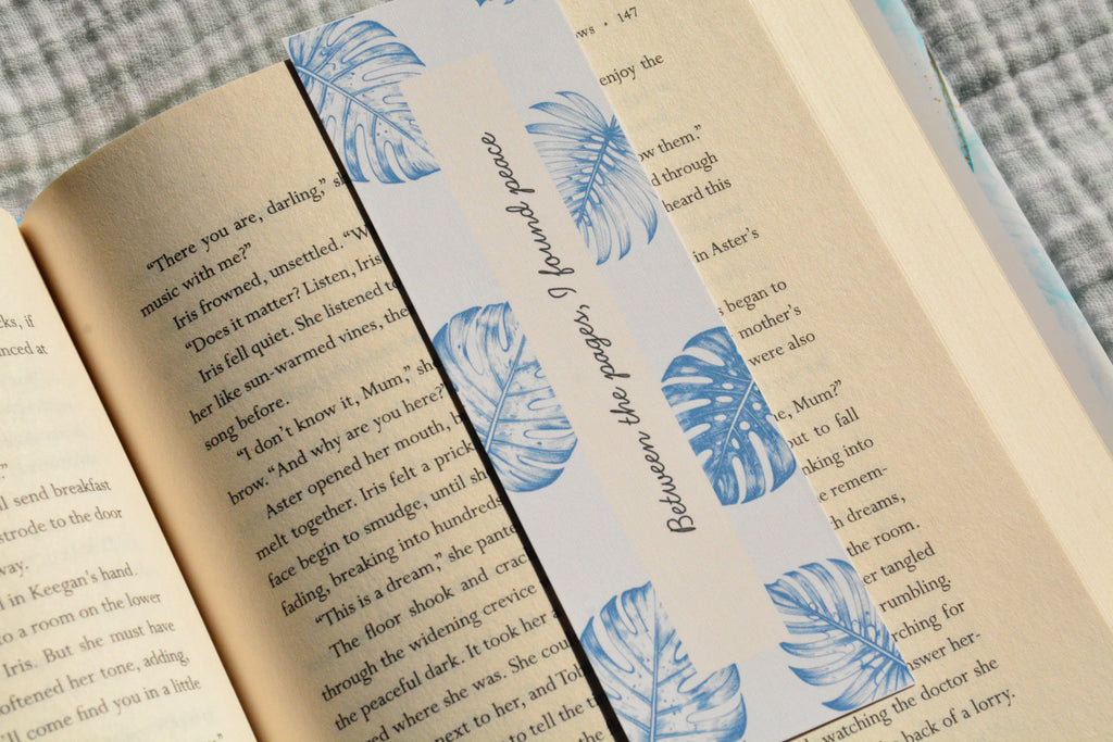 Handcrafted botanical linen bookmark with a calming blue leaf design and inspirational reading quote.