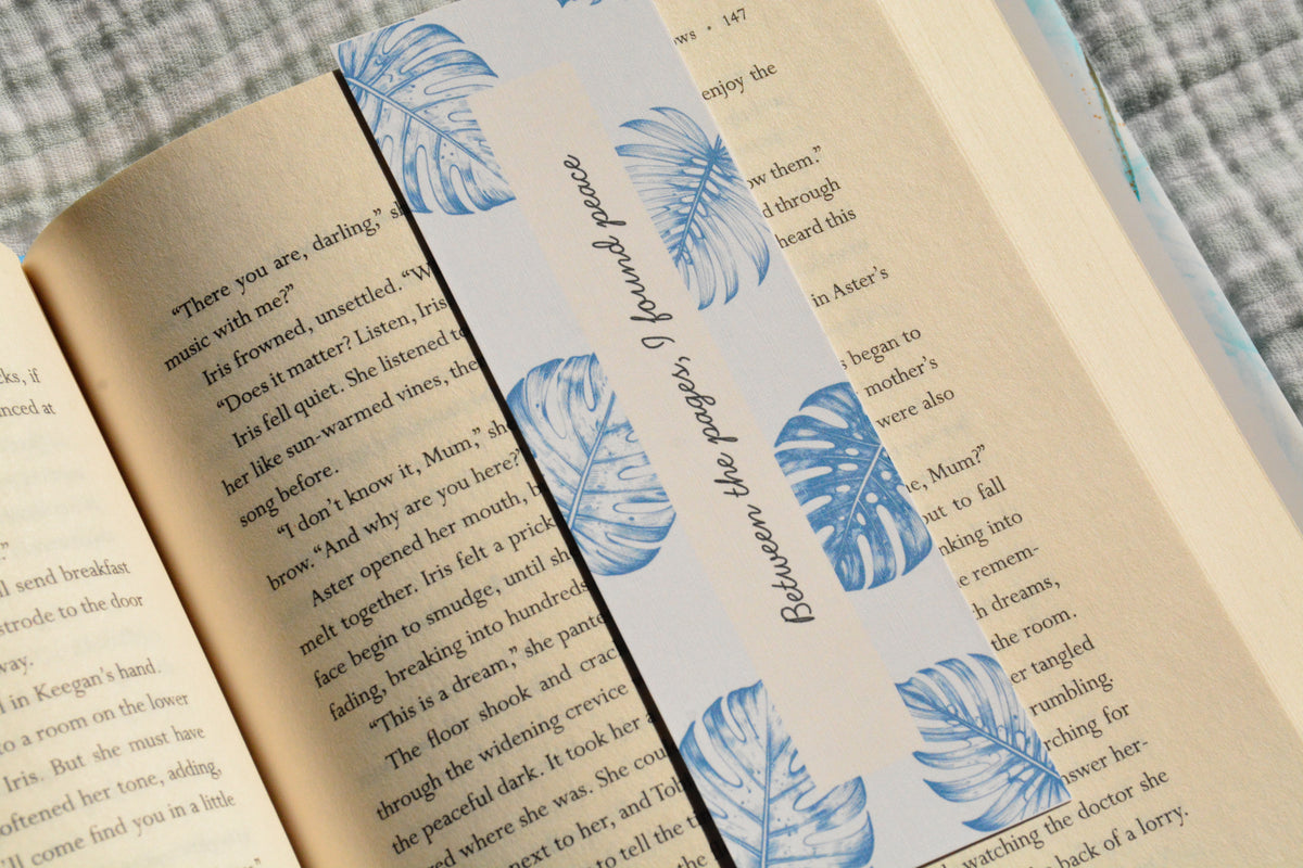 Handcrafted botanical linen bookmark with a calming blue leaf design and inspirational reading quote.