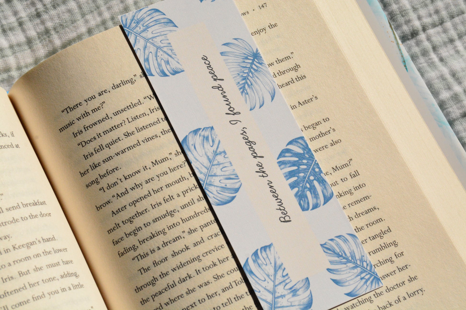 Handcrafted botanical linen bookmark with a calming blue leaf design and inspirational reading quote.