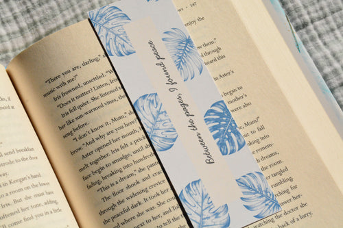 Handcrafted botanical linen bookmark with a calming blue leaf design and inspirational reading quote.