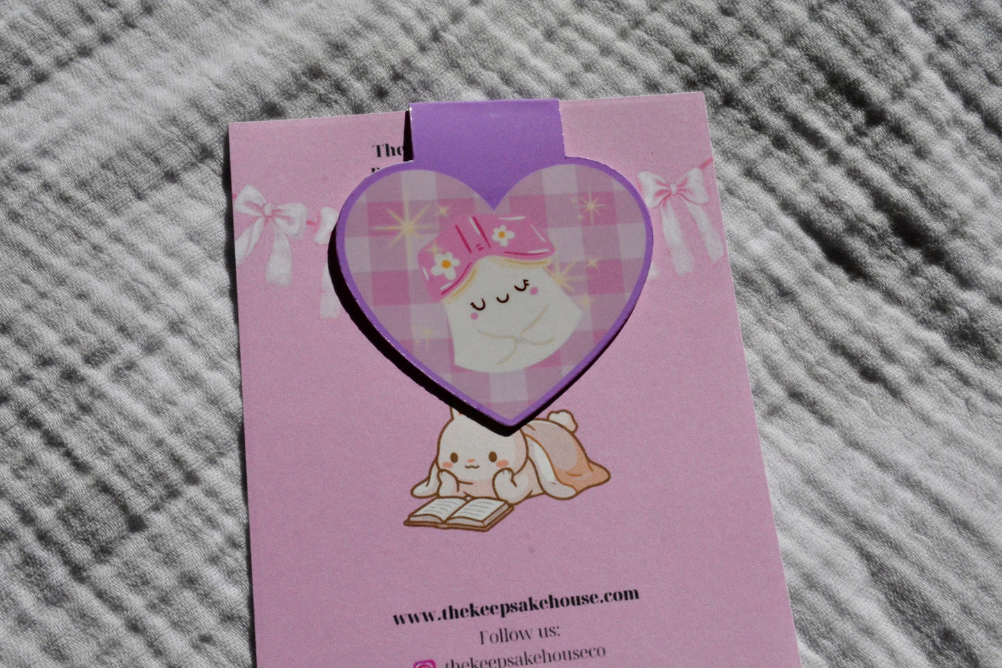 Handmade cute ghost magnetic bookmark reading a stack of pink books on a pink Keepsake House backing card