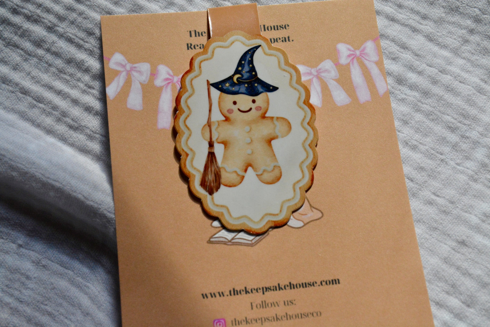 Handmade wizard gingerbread magnetic bookmark with starry hat and broom on a tan Keepsake House backing card