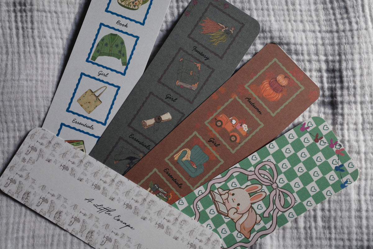 five illustrated linen bookmarks bundle on grey background