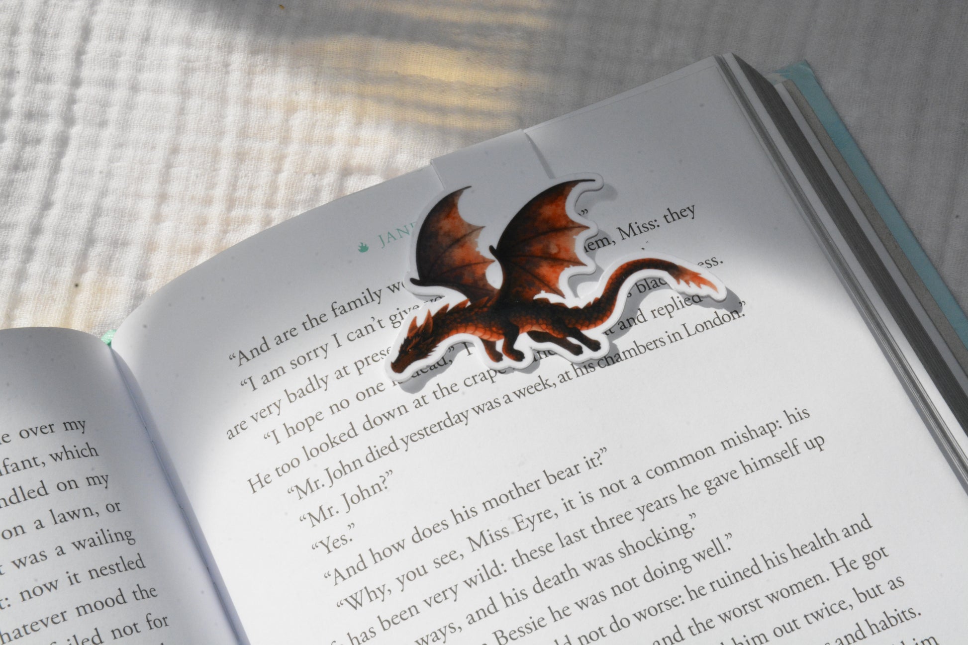 Handmade magnetic bookmark featuring a cute kawaii dragon design on a pink Keepsake House backing card