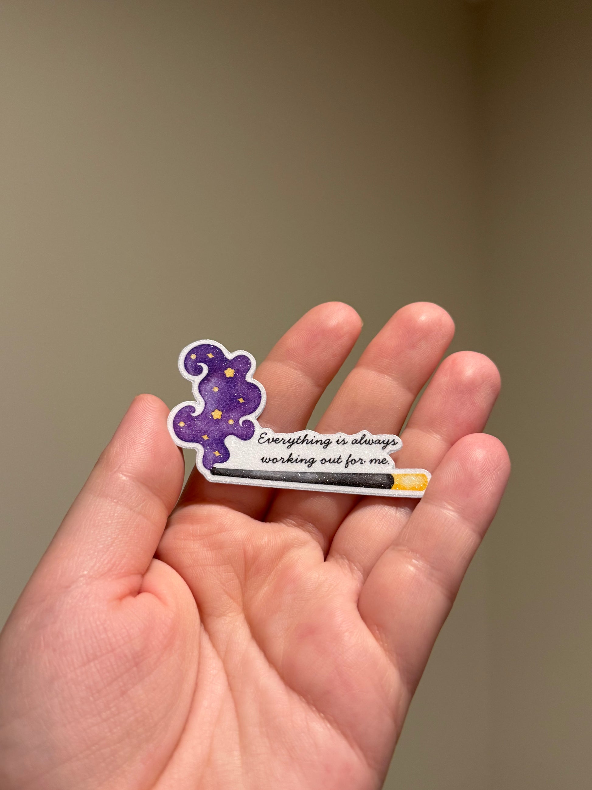 Purple glitter affirmation sticker with the quote "Everything is always working out for me" displayed in hand for Kindles, journals, planners, laptops, and water bottles.