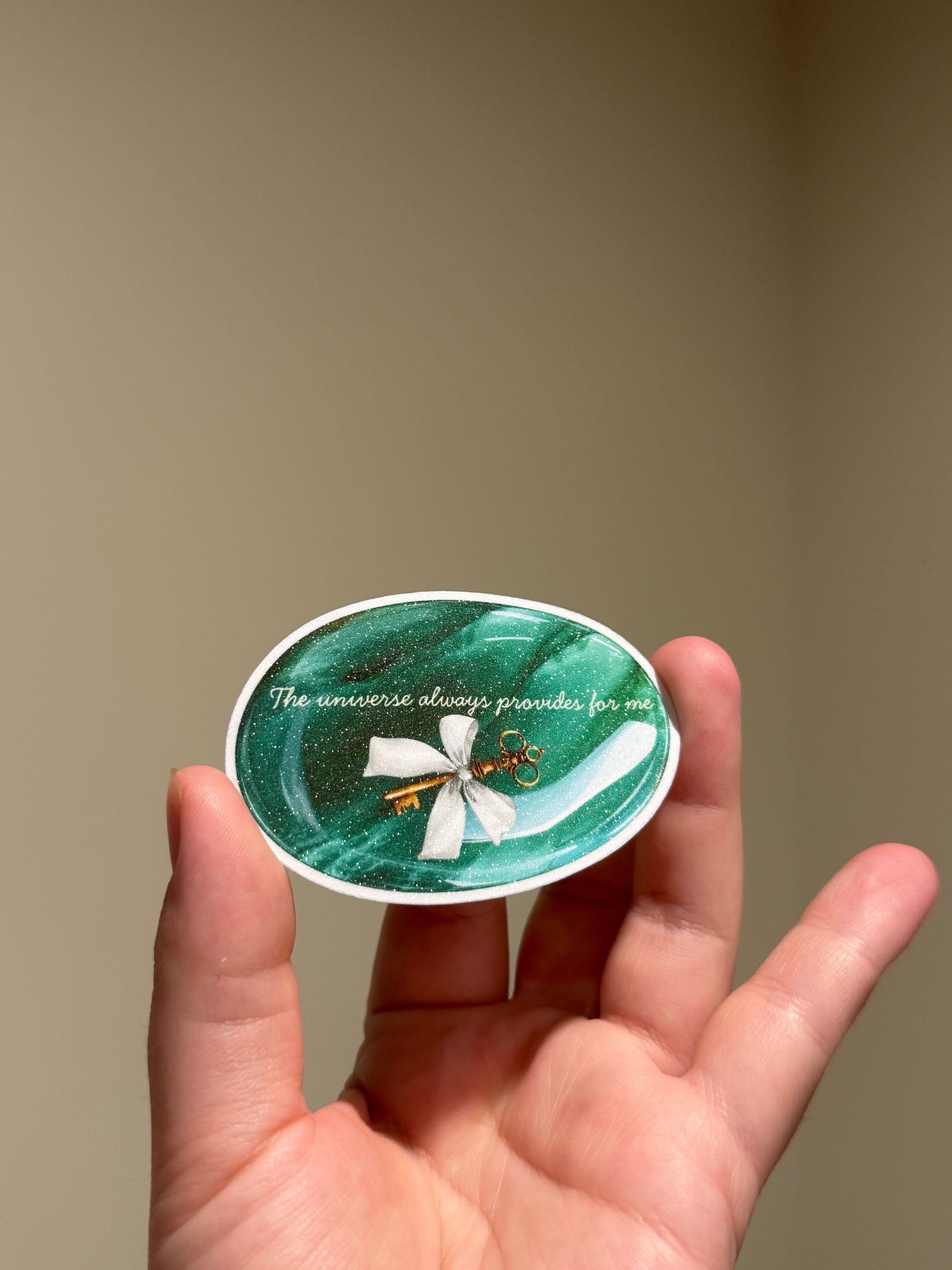 Green glitter affirmation sticker with the quote "The universe always provides for me" for Kindles, journals, planners, laptops, and water bottles.
