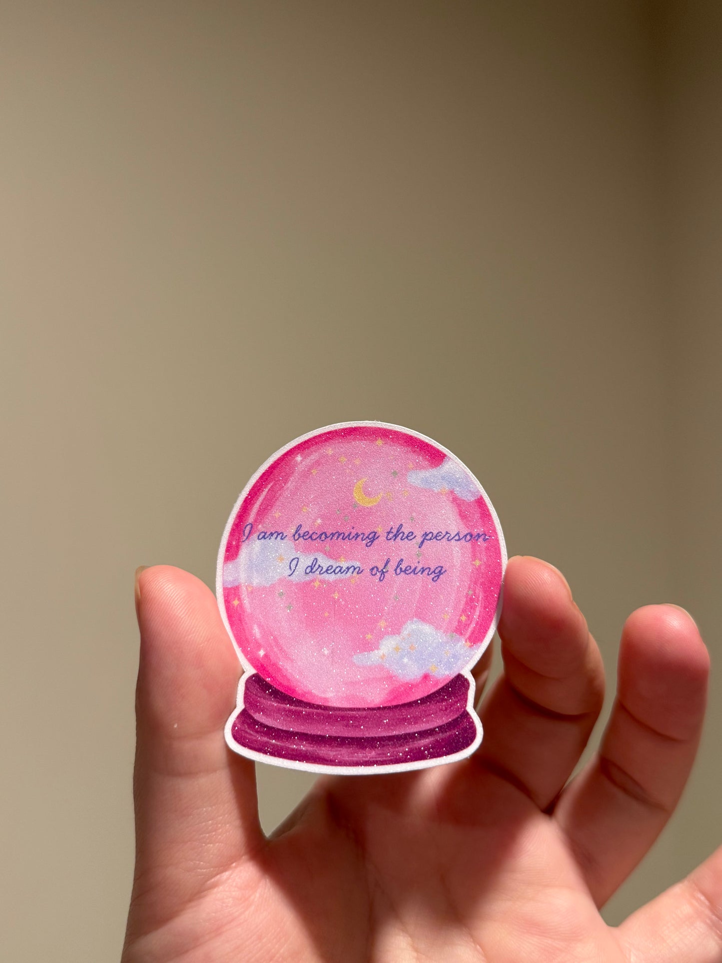 Pink crystal ball glitter affirmation sticker with the quote "I am becoming the person I dream of being."