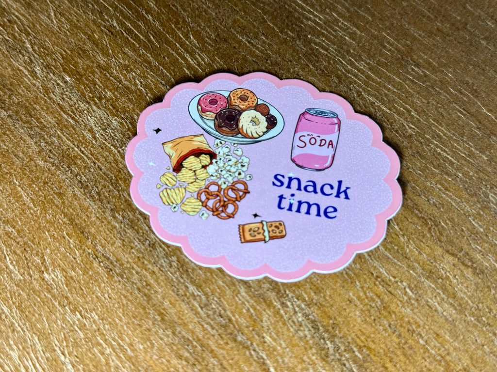 Cute "Snack Time" sticker featuring donuts, popcorn, chips, pretzels, cookies, and a soda on a pastel pink background with a transparent laminate finish.