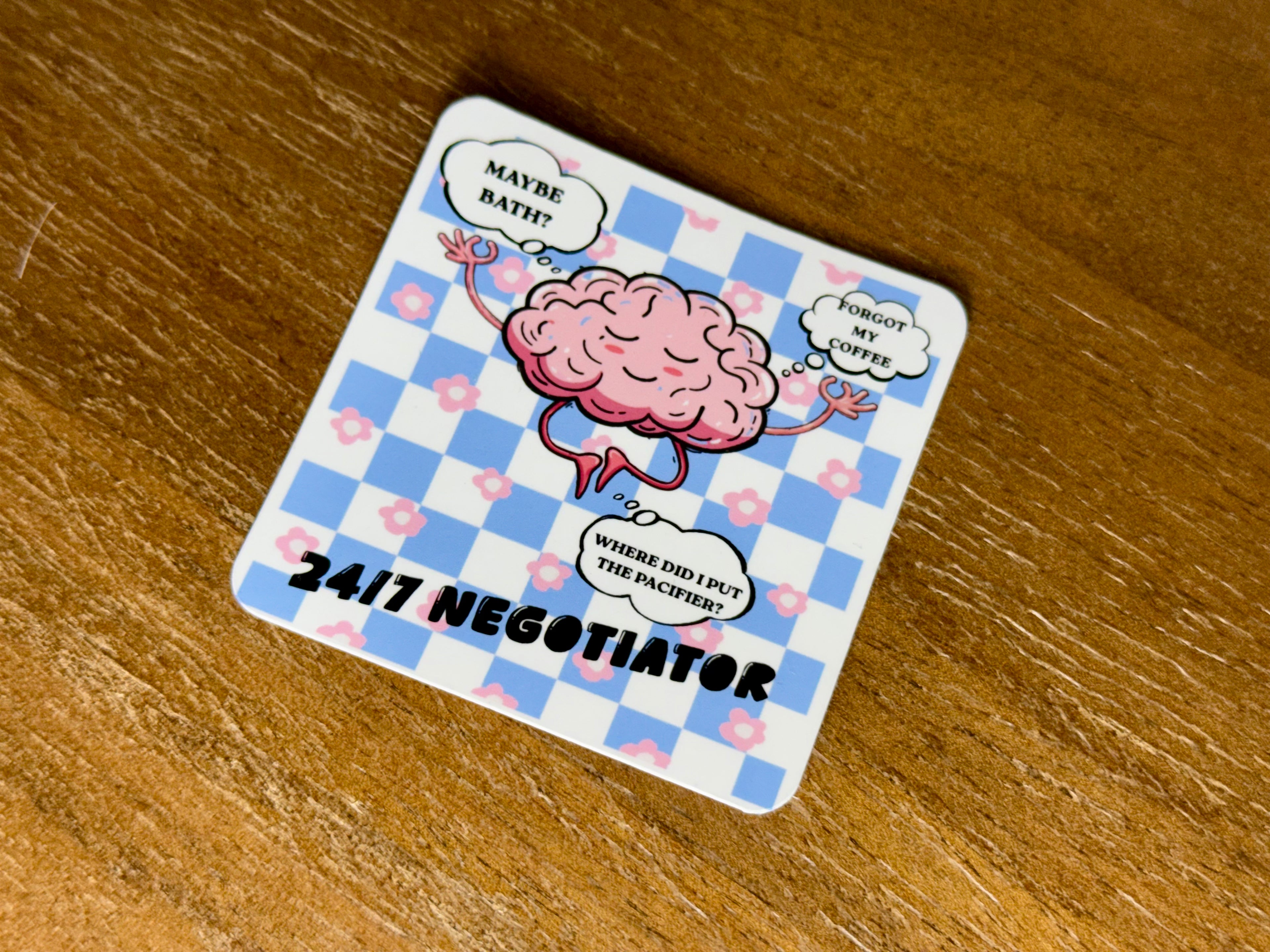 Funny "24/7 Negotiator" sticker featuring a cute cartoon brain with humorous parenting thoughts on a blue gingham background.