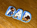 Cute "Dad" sticker featuring a father and child illustration incorporated into the lettering with a transparent laminate finish.