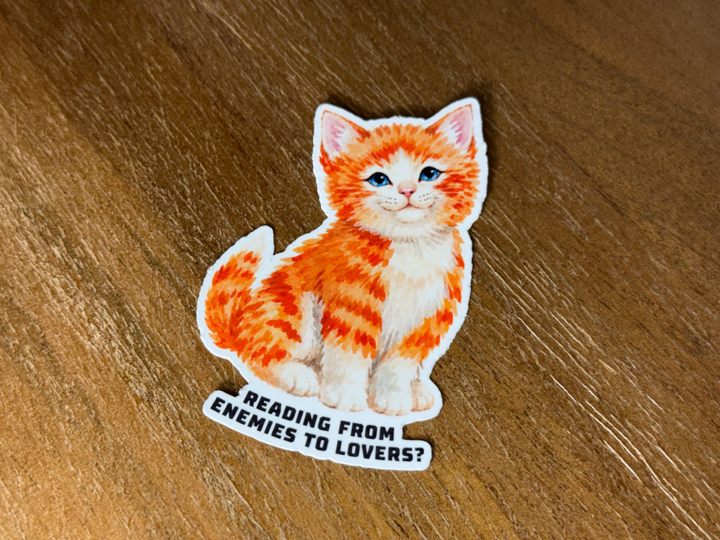 Watercolor orange kitten sticker with the quote "Reading from Enemies to Lovers?" finished with a transparent laminate.