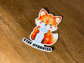 Cute watercolor fox sticker drinking from a tumbler with the words "Stay Hydrated" and a transparent laminate finish.