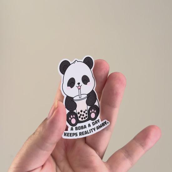 A boba a day keeps reality away sticker showcased from different angles showing it's holographic finish