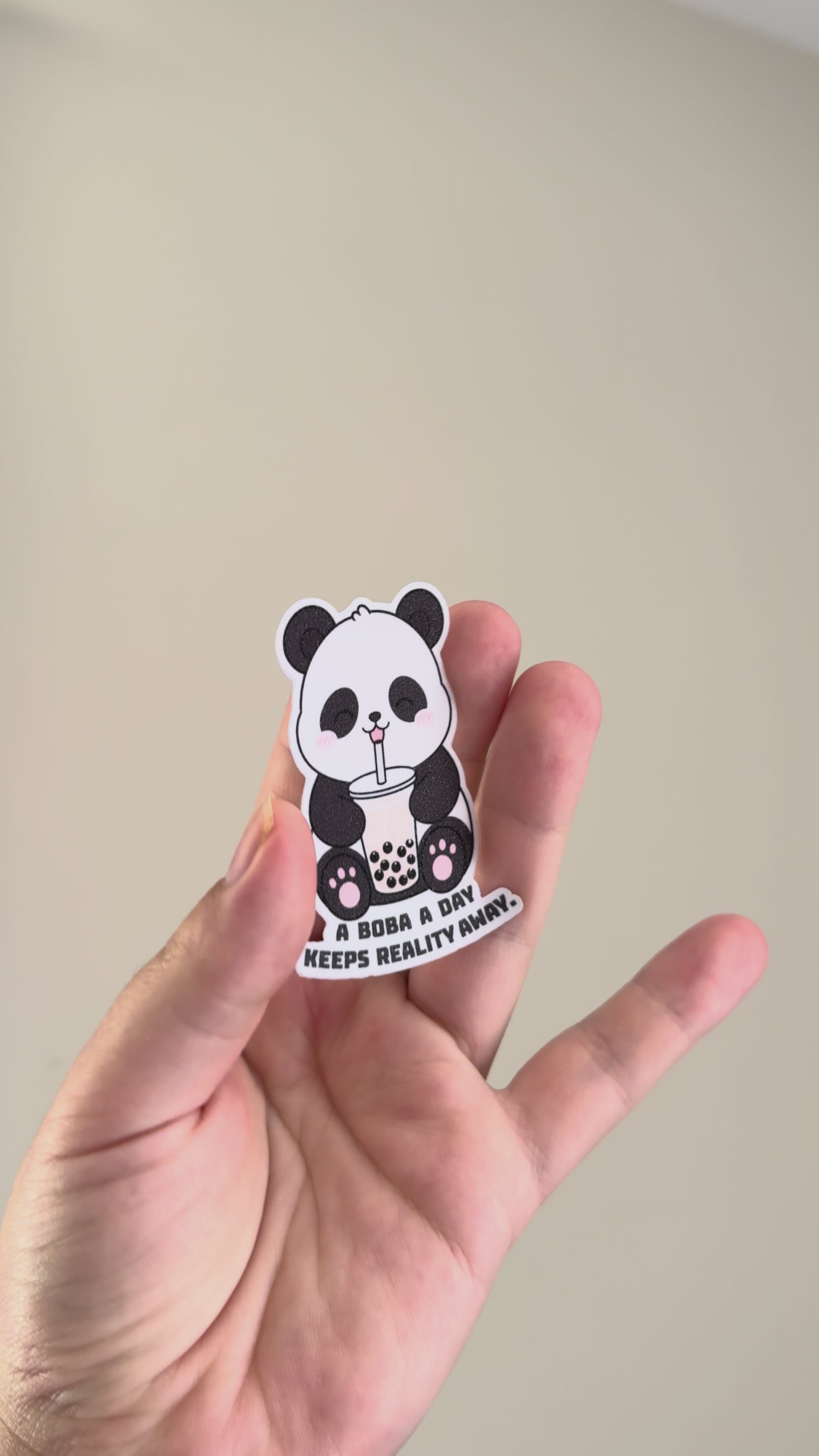 A boba a day keeps reality away sticker showcased from different angles showing it's holographic finish