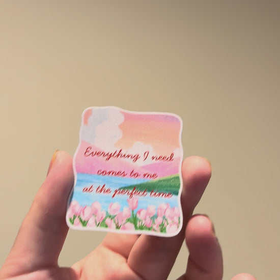 Close-up video of a watercolor tulip affirmation sticker with glitter laminate, highlighting its sparkling finish, vibrant colors, and handmade details from different angles.