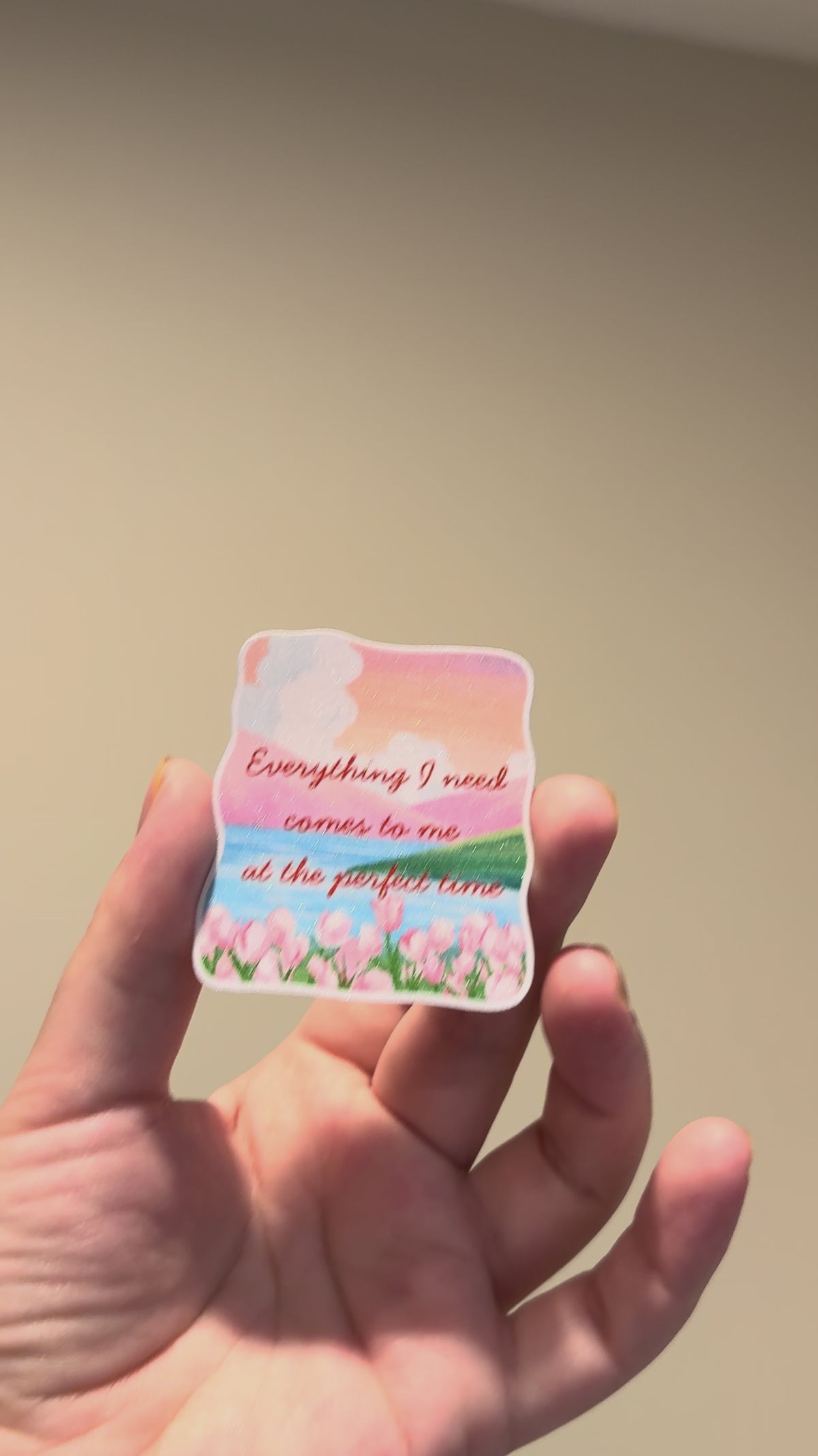 Close-up video of a watercolor tulip affirmation sticker with glitter laminate, highlighting its sparkling finish, vibrant colors, and handmade details from different angles.