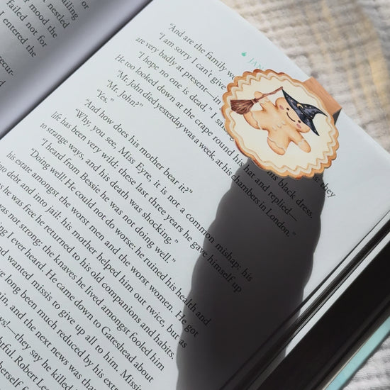 Wizard gingerbread magnetic bookmark demo: magical holiday design clips onto book pages with strong magnet, shown on pink Keepsake House backing card