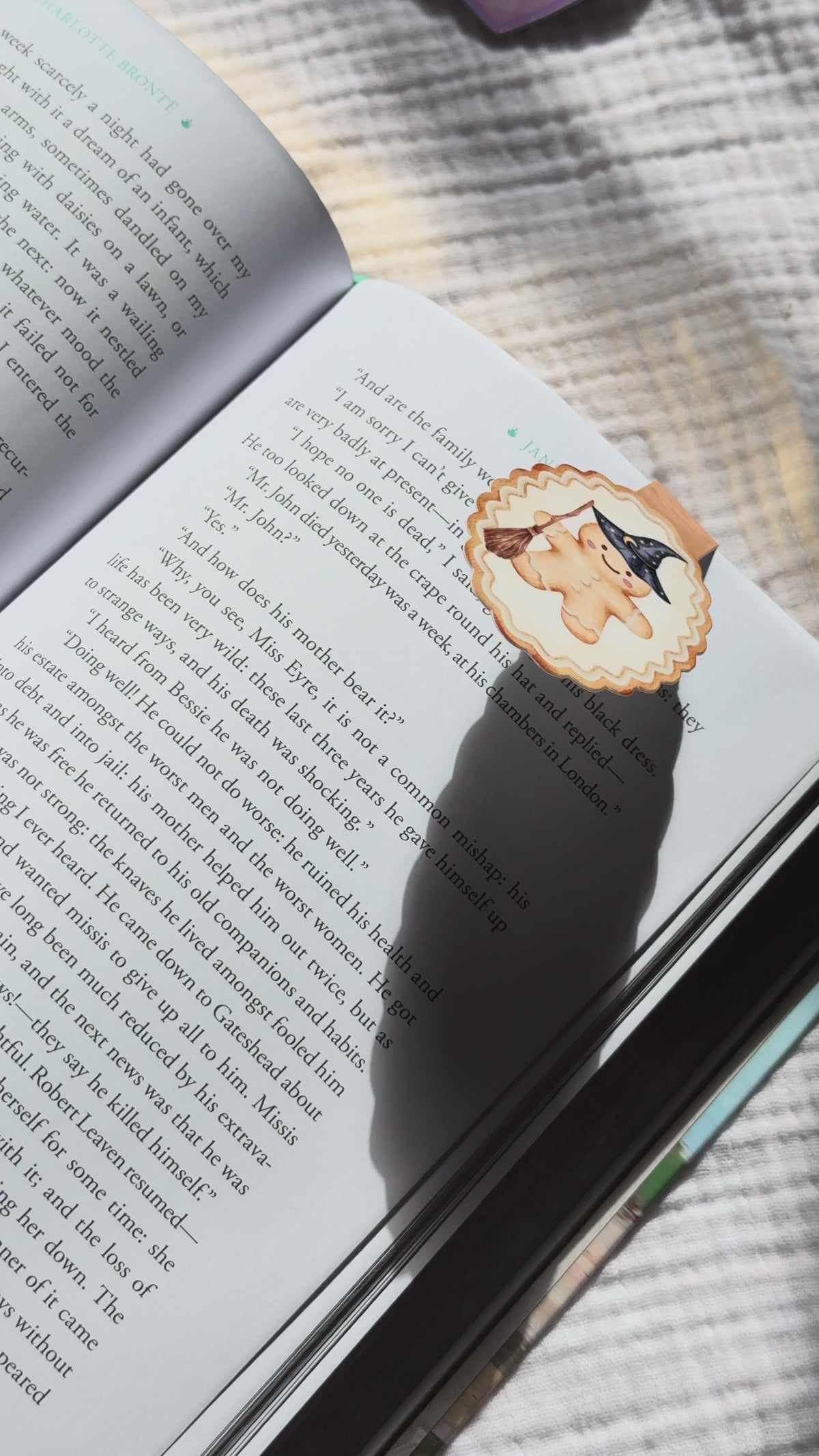 Wizard gingerbread magnetic bookmark demo: magical holiday design clips onto book pages with strong magnet, shown on pink Keepsake House backing card
