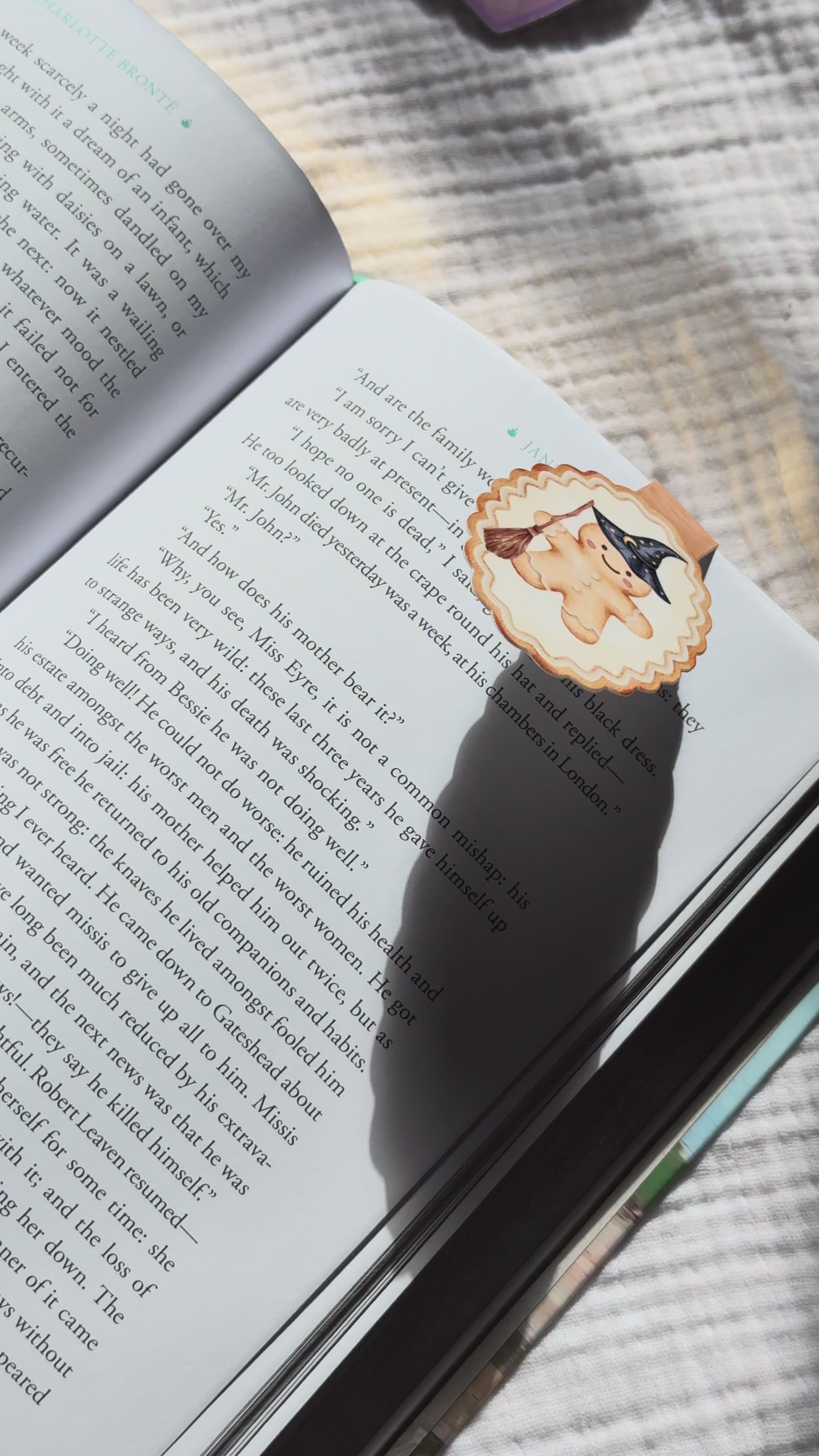 Wizard gingerbread magnetic bookmark demo: magical holiday design clips onto book pages with strong magnet, shown on pink Keepsake House backing card