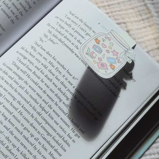 Cottagecore mason jar magnetic bookmark demo: cute jar design clips onto book or planner pages with strong magnet, shown on pink Keepsake House backing card