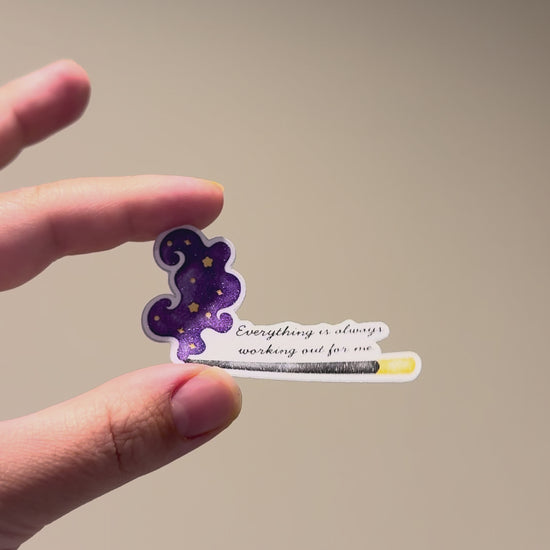 Close-up video of a glitter affirmation sticker with a celestial incense design, showing its sparkle and premium finish from different angles.