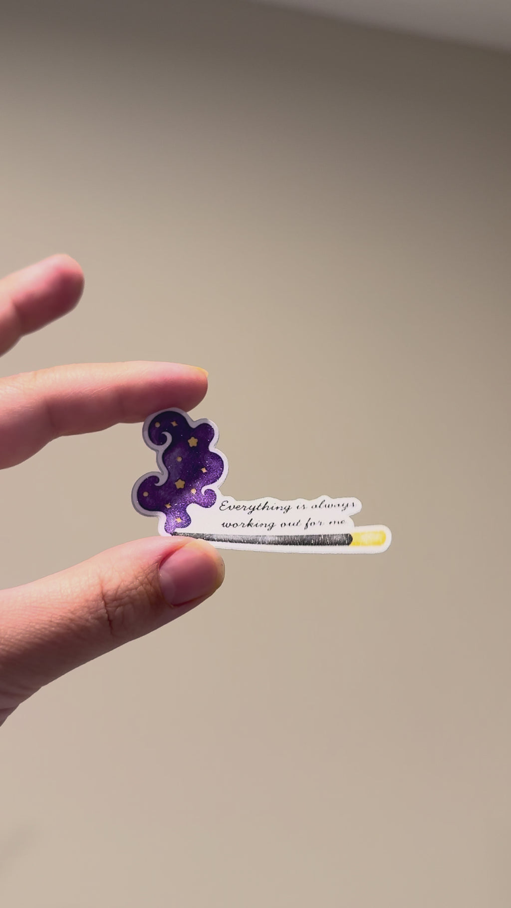 Close-up video of a glitter affirmation sticker with a celestial incense design, showing its sparkle and premium finish from different angles.