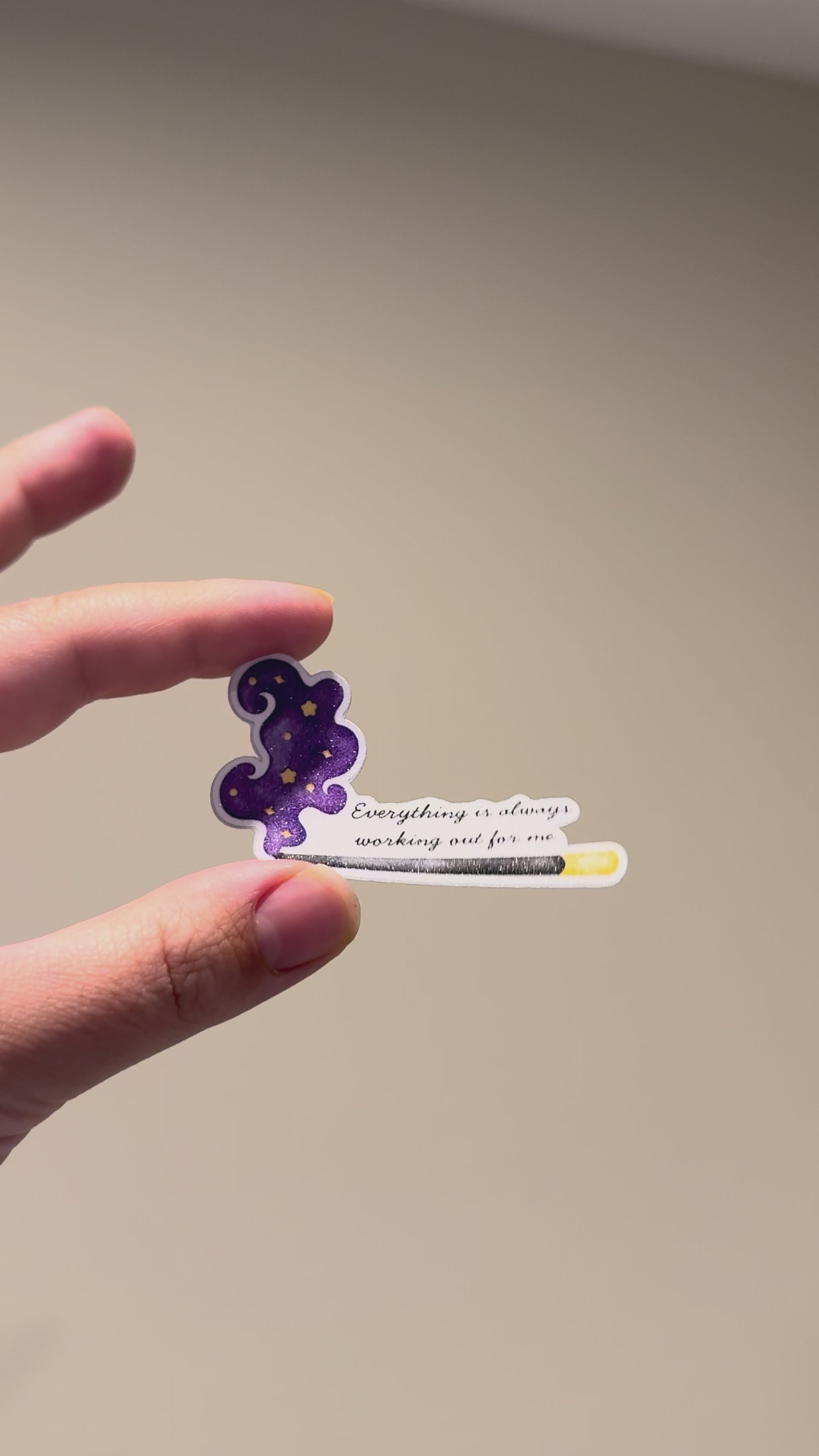 Close-up video of a glitter affirmation sticker with a celestial incense design, showing its sparkle and premium finish from different angles.