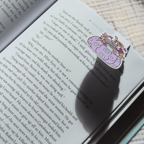 Pumpkin stacked with books magnetic bookmark demo: cozy fall design clips securely onto pages with strong magnet, shown on pink Keepsake House backing card