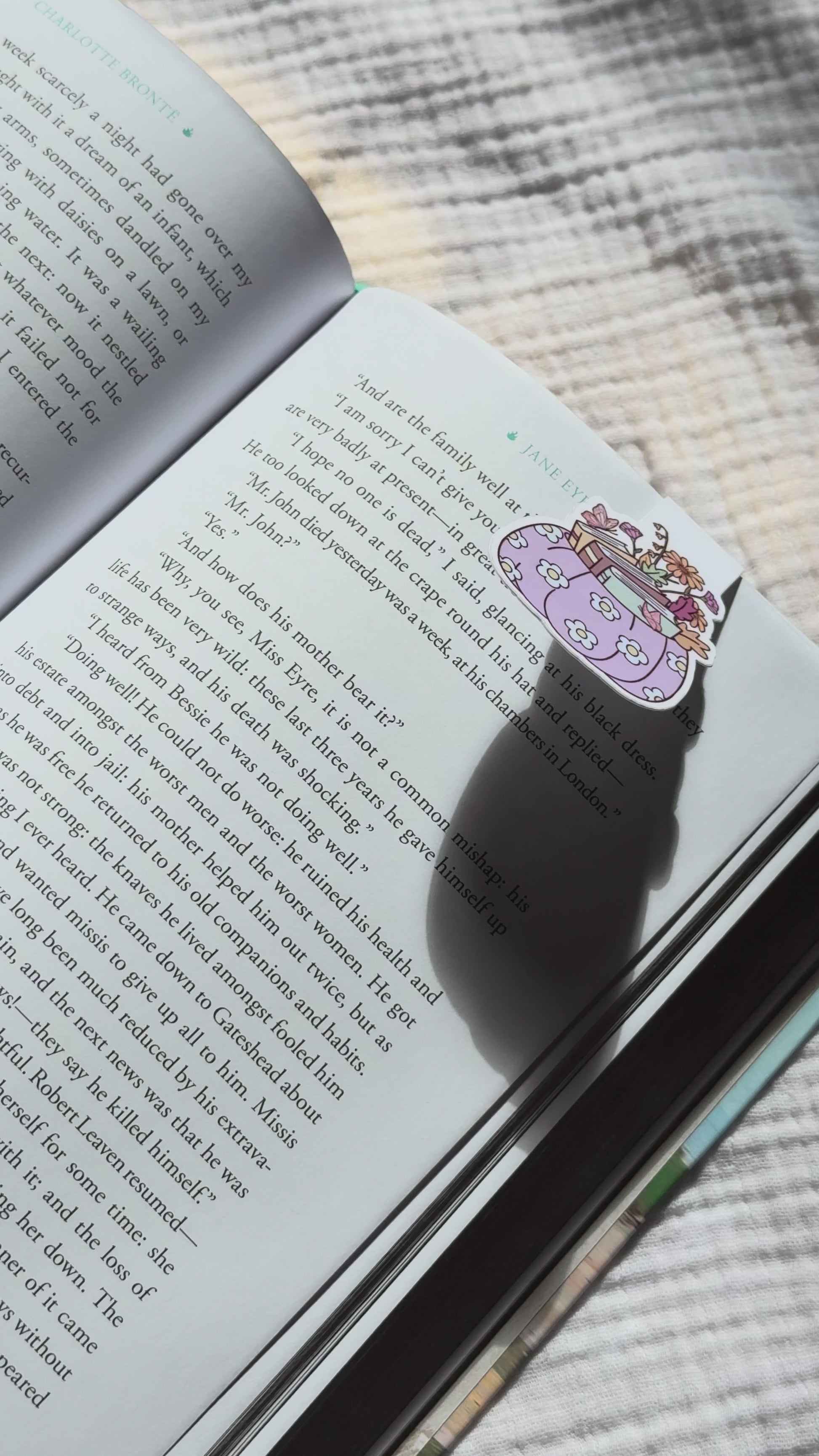 Pumpkin stacked with books magnetic bookmark demo: cozy fall design clips securely onto pages with strong magnet, shown on pink Keepsake House backing card