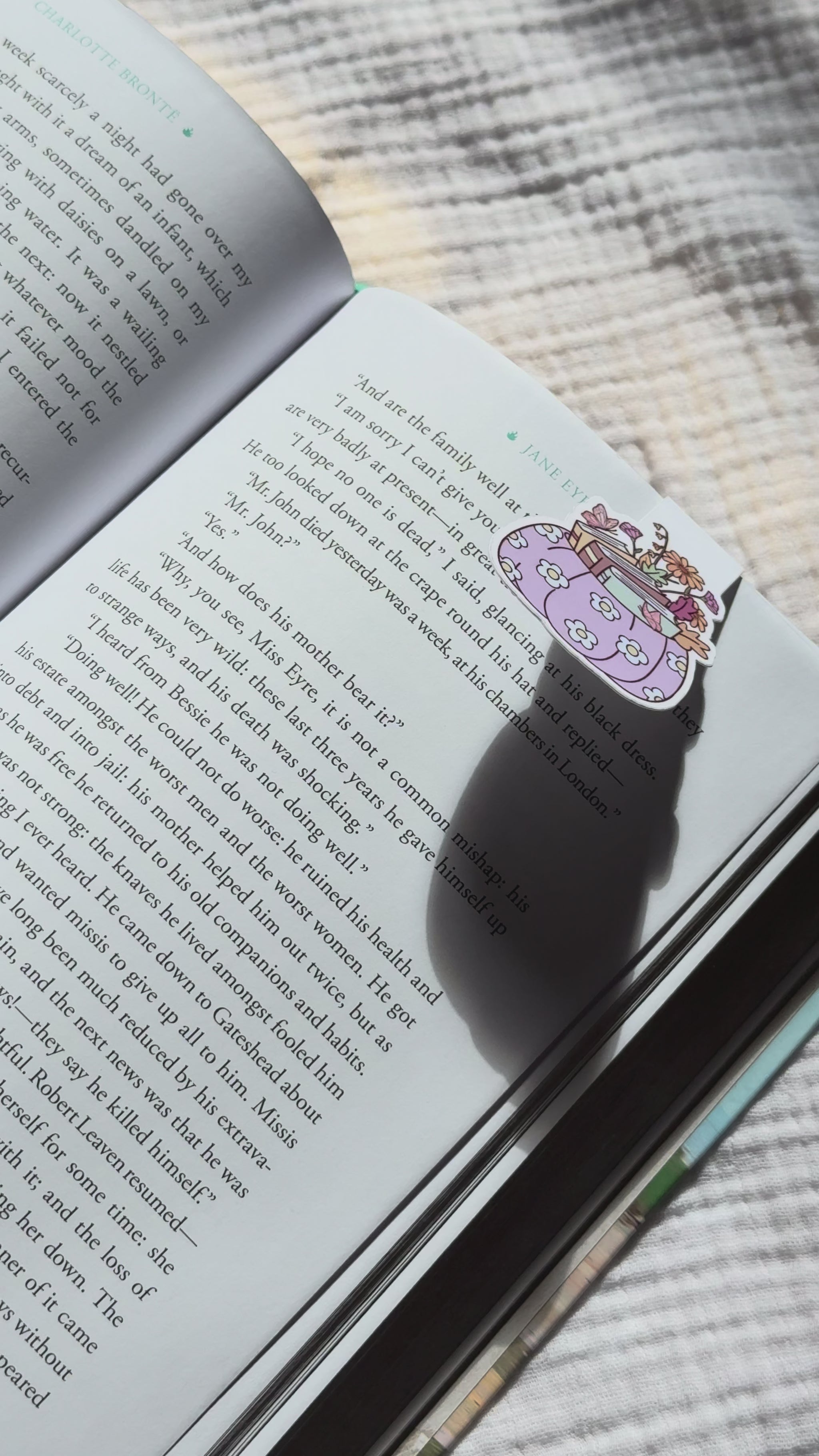 Pumpkin stacked with books magnetic bookmark demo: cozy fall design clips securely onto pages with strong magnet, shown on pink Keepsake House backing card