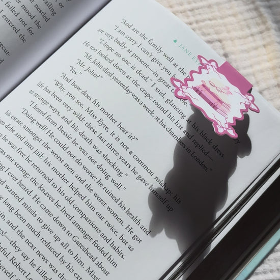 Sleeping ghost magnetic bookmark demo: kawaii bookish ghost with reading glasses clips onto book pages with strong magnet, shown on Keepsake House backing card