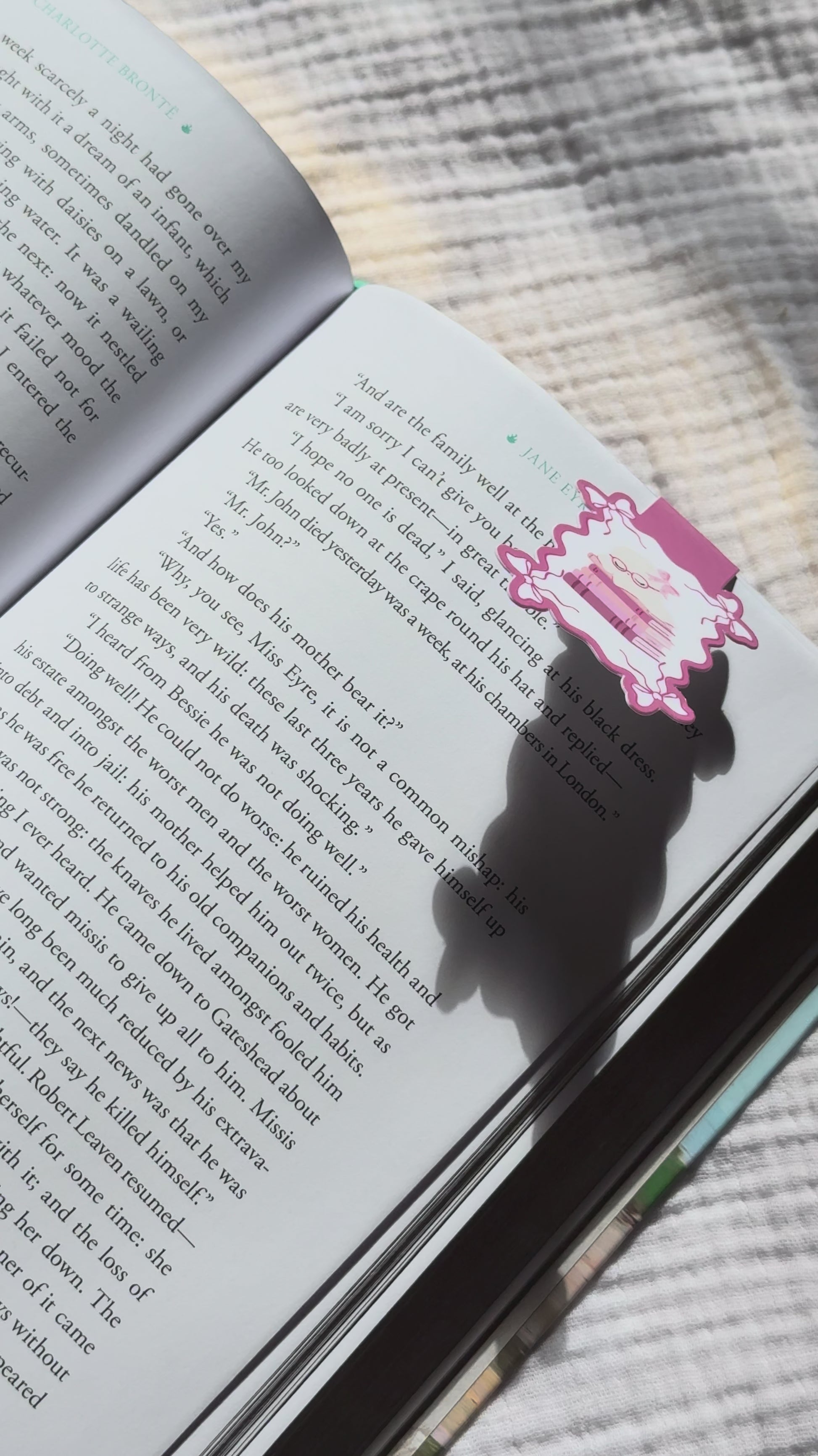 Sleeping ghost magnetic bookmark demo: kawaii bookish ghost with reading glasses clips onto book pages with strong magnet, shown on Keepsake House backing card