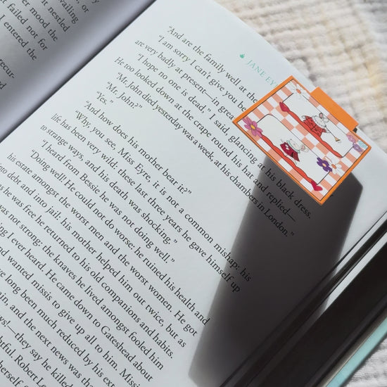 Magnetic bookmark demo: adorable kawaii bunny design slides onto book page and stays put with strong magnet, shown on pink Keepsake House backing card