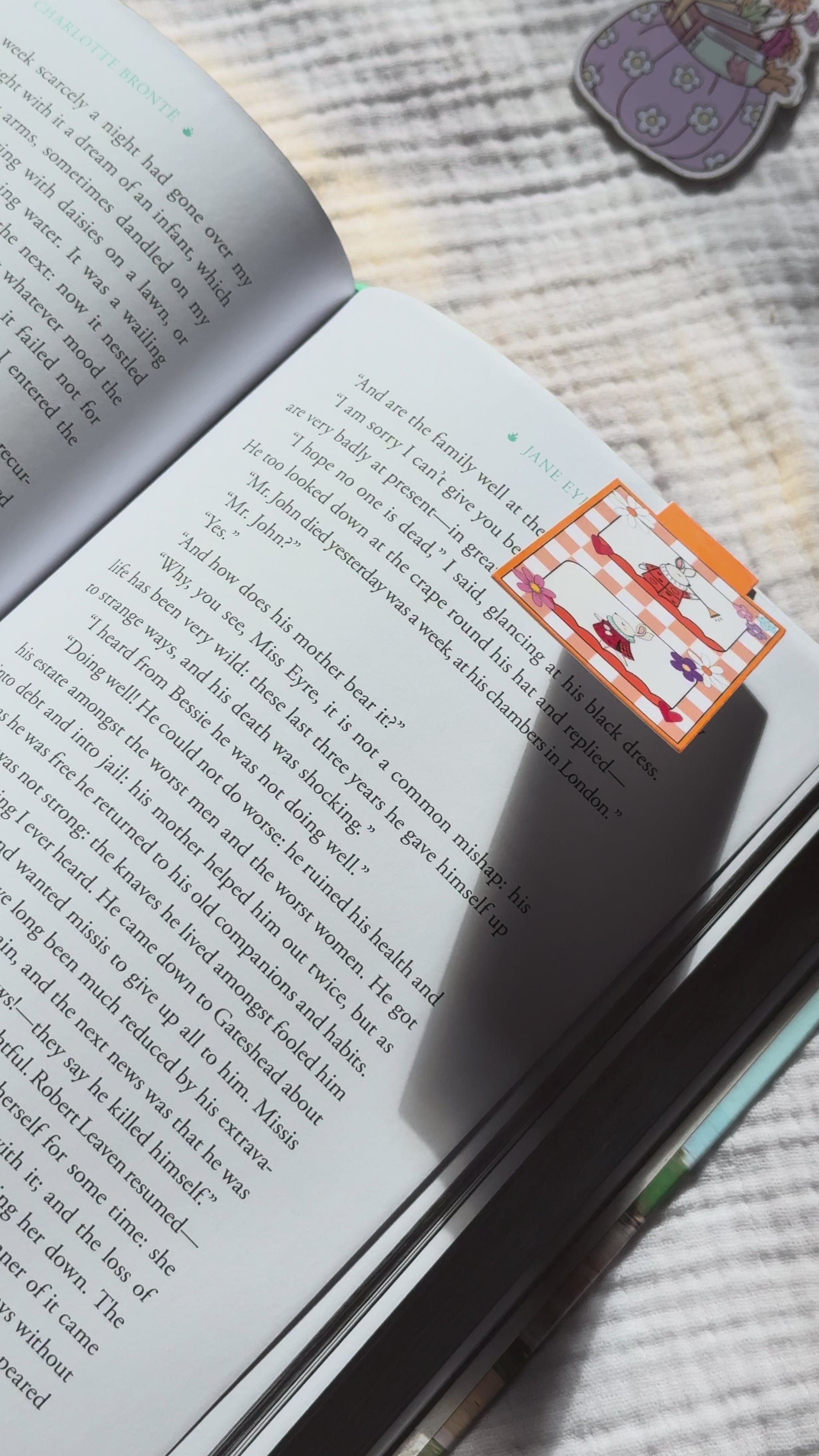 Magnetic bookmark demo: adorable kawaii bunny design slides onto book page and stays put with strong magnet, shown on pink Keepsake House backing card